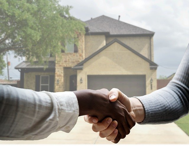 A realtor in Fayetteville shaking hands with a client.